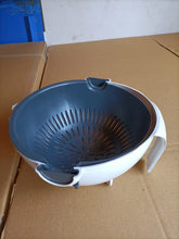 Kitchen bowl and strainer with handle for washing and draining produce.