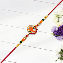 Golden Ganesha Rakhi With Red-green Beads And Stone Detailing