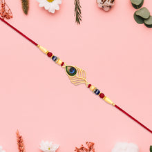 Peacock Feather Design Rakhi With Beaded Detailing And Red Thread