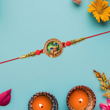 Traditional Krishna Rakhi With Peacock Feather Design And Decorative Beads On Red Thread